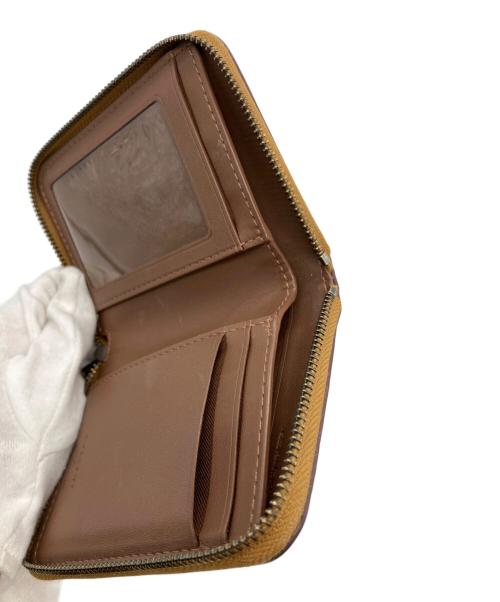 COACH（コーチ）COACH (コーチ) PEANUTS (ピーナッツ) ラウンドジップウォレット イエローの古着・服飾アイテム