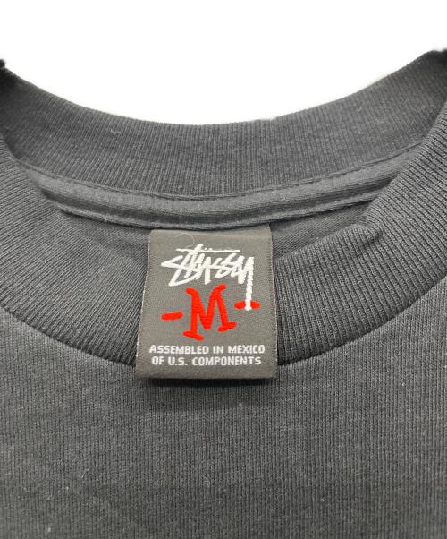 stussy（ステューシー）stussy (ステューシー) NEXUSVII (ネクサスセブン) プリントTシャツ ブラック サイズ:Mの古着・服飾アイテム