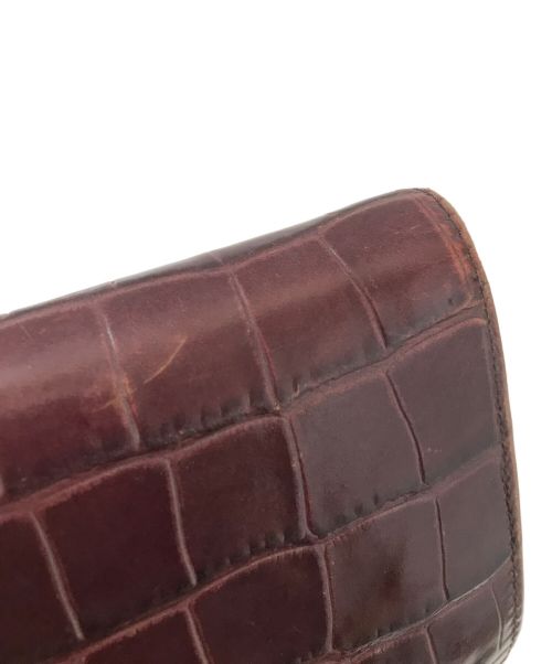 ALEXANDER McQUEEN（アレキサンダーマックイーン）ALEXANDER McQUEEN (アレキサンダーマックイーン) スカルトップクロコダイルウォレット ボルドーの古着・服飾アイテム