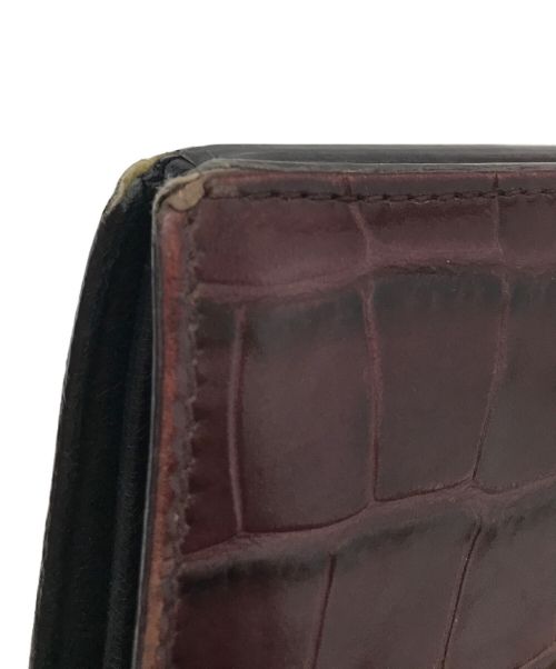 ALEXANDER McQUEEN（アレキサンダーマックイーン）ALEXANDER McQUEEN (アレキサンダーマックイーン) スカルトップクロコダイルウォレット ボルドーの古着・服飾アイテム