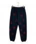Unknown（アンノウン）の古着「Cross Rhinestone Jogger Pants」｜ブラック