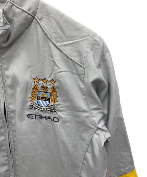 UMBRO（アンブロ）UMBRO (アンブロ) Manchester City トラックジャケット グレー サイズ:Mの古着・服飾アイテム