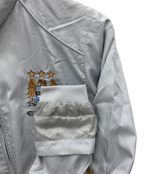 UMBRO（アンブロ）UMBRO (アンブロ) Manchester City トラックジャケット グレー サイズ:Mの古着・服飾アイテム
