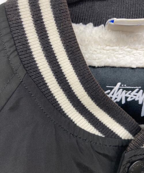 Champion（チャンピオン）Champion (チャンピオン) stussy (ステューシー) ロゴナイロンスタジャン ブラック サイズ:Mの古着・服飾アイテム