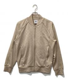 adidas（アディダス）の古着「グラフィックモノグラムSST トラックトップ」｜ベージュ