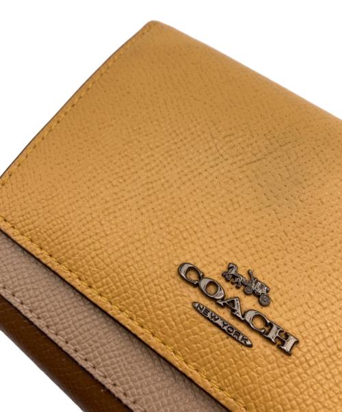 COACH（コーチ）COACH (コーチ) 2つ折り財布 イエロー×ブラウンの古着・服飾アイテム