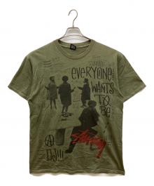 stussy（ステューシー）の古着「00s フォト グラフィック クルーネック 半袖 Tシャツ　EVERYONE WANTS TO BE」｜カーキ