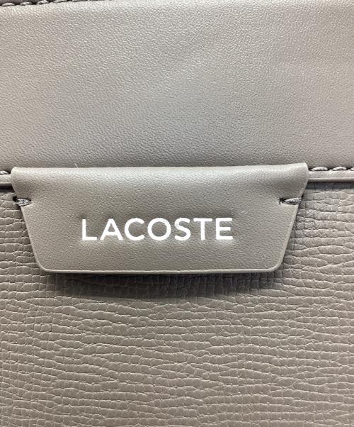 LACOSTE（ラコステ）LACOSTE (ラコステ) オシアン レザーレポーターバッグ ベージュの古着・服飾アイテム