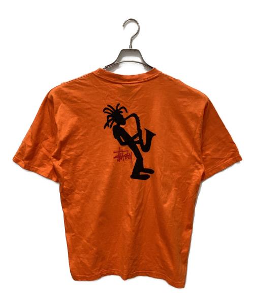 stussy（ステューシー）stussy (ステューシー) JAZZ SHADOW MAN T-SHIRT オレンジ サイズ:LARGEの古着・服飾アイテム