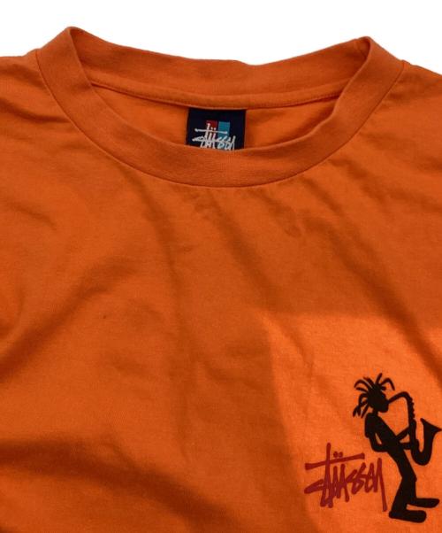 stussy（ステューシー）stussy (ステューシー) JAZZ SHADOW MAN T-SHIRT オレンジ サイズ:LARGEの古着・服飾アイテム