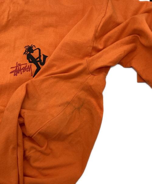 stussy（ステューシー）stussy (ステューシー) JAZZ SHADOW MAN T-SHIRT オレンジ サイズ:LARGEの古着・服飾アイテム
