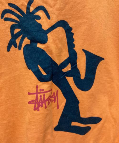 stussy（ステューシー）stussy (ステューシー) JAZZ SHADOW MAN T-SHIRT オレンジ サイズ:LARGEの古着・服飾アイテム