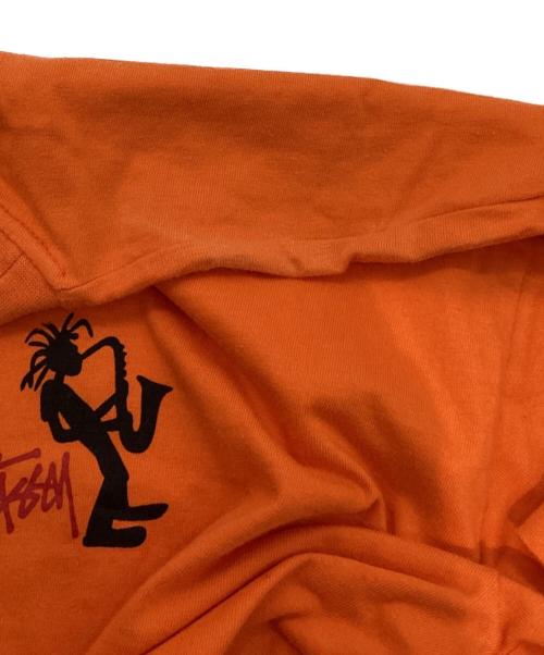 stussy（ステューシー）stussy (ステューシー) JAZZ SHADOW MAN T-SHIRT オレンジ サイズ:LARGEの古着・服飾アイテム