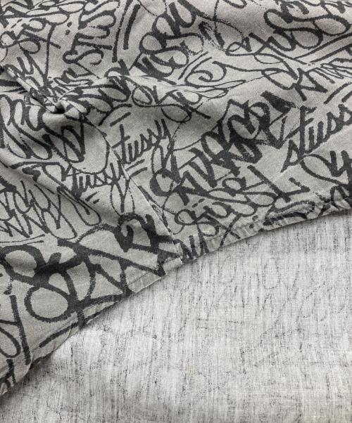 stussy（ステューシー）stussy (ステューシー) 90sグラフィックプリントシャツ  OLD   USA製 紺タグ グレー サイズ:Lの古着・服飾アイテム