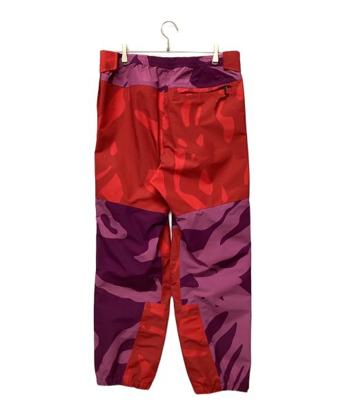 THE NORTH FACE（ザ ノース フェイス）THE NORTH FACE (ザ ノース フェイス) KAWS (カウズ) トラックパンツ ピンク×パープル サイズ:Lの古着・服飾アイテム