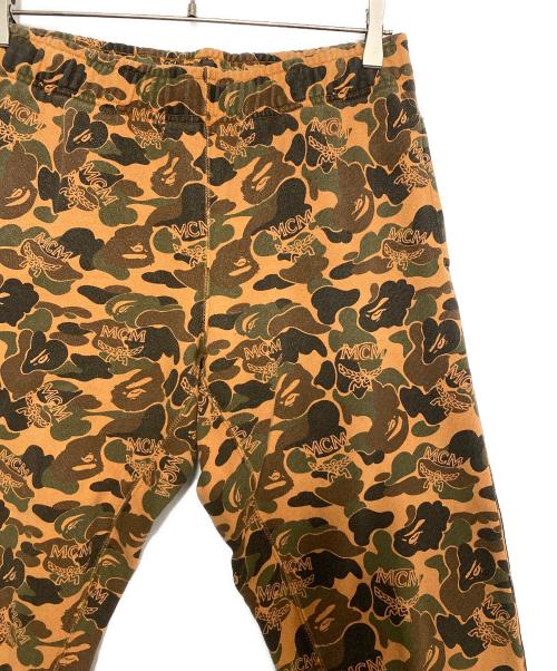 A BATHING APE（ア ベイシング エイプ）A BATHING APE (ア ベイシング エイプ) MCM (エムシーエム) Camo Slim Sweat Pants オレンジ サイズ:Sの古着・服飾アイテム