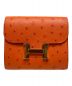 HERMES（エルメス）の古着「コンスタンスコンパクトウォレット」｜オレンジ