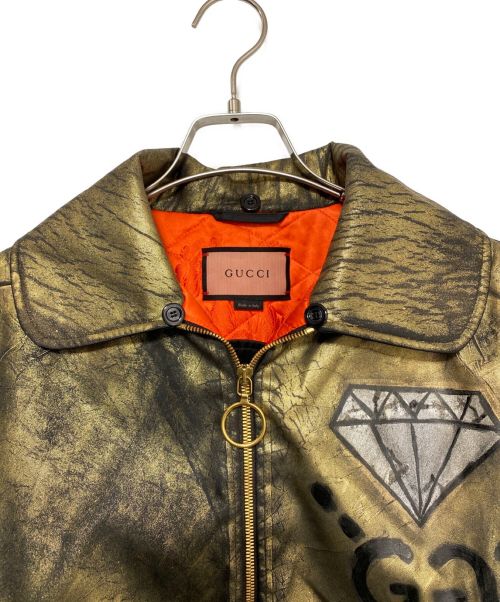 GUCCI（グッチ）GUCCI (グッチ) Trouble Andrew (トラブル アンドリュー) GUCCI GHOST MA-1 BOMBER JACKET ゴールド サイズ:38の古着・服飾アイテム