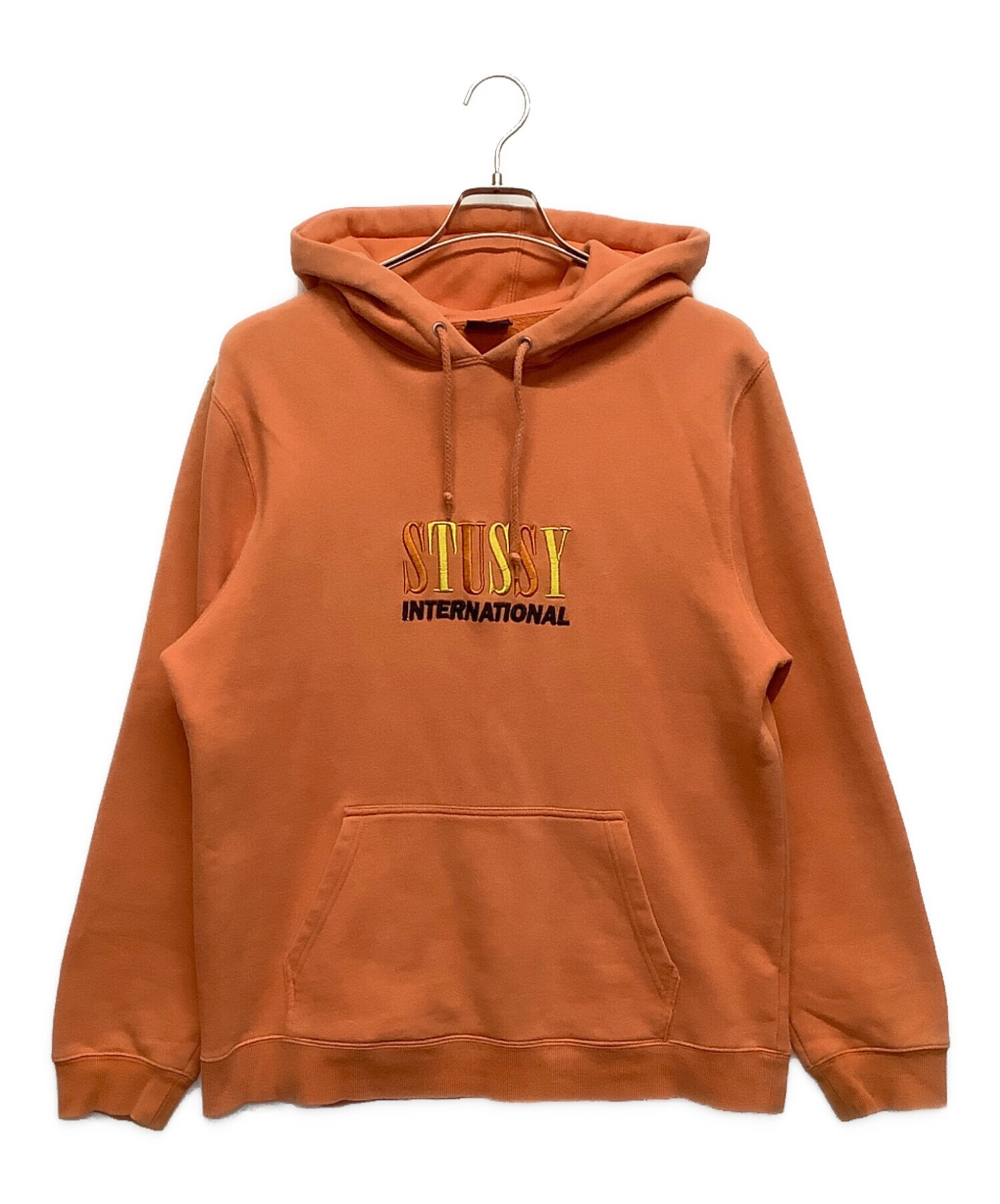ストゥーシー オレンジパーカー 中古・古着通販】stussy (ステューシー) パーカー オレンジ サイズ:L