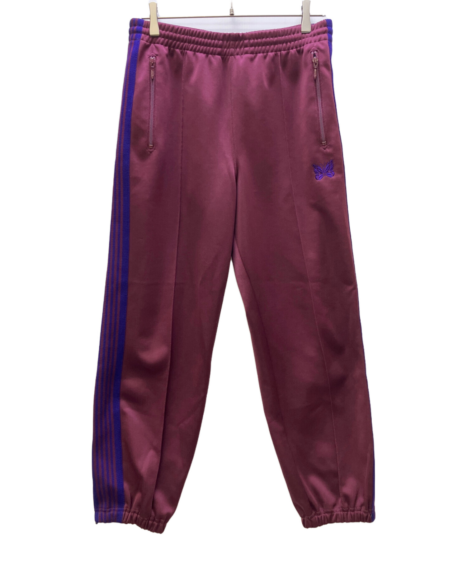 Needles トラックパンツ マスタード Sサイズ 中古・古着通販】Needles (ニードルズ) トラックパンツ パープル