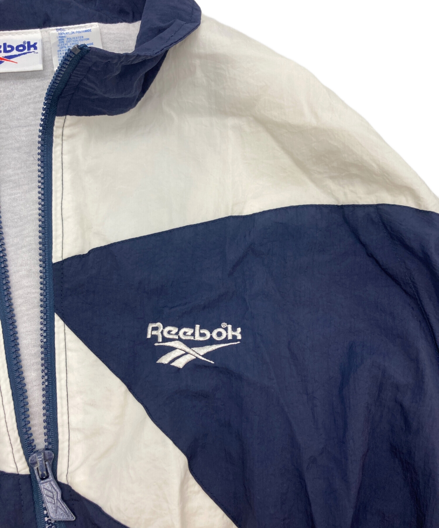 Reebok ネイビー ジャケット Lサイズ 中古・古着通販】REEBOK (リーボック) ナイロンジャケット ネイビー